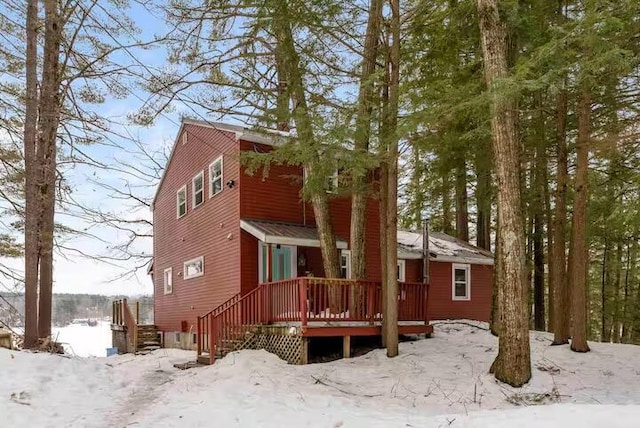 view of snow covered rear of property