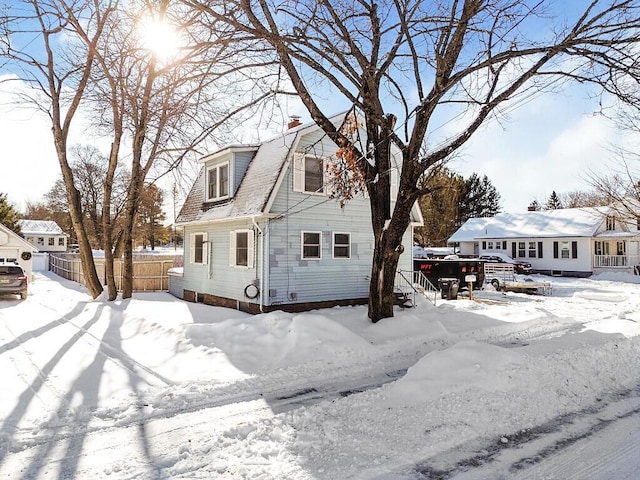 view of front of home featuring fence and a chimney