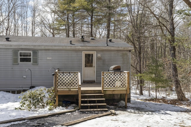 snow covered property featuring a wooden deck