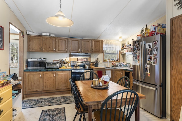 kitchen featuring ventilation hood, brown cabinetry, a wealth of natural light, and stainless steel appliances