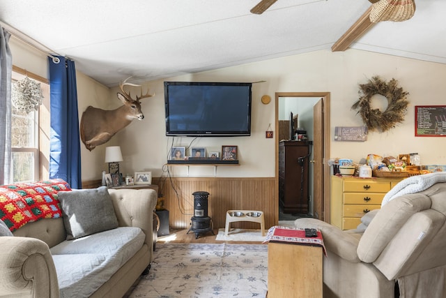 living area with lofted ceiling with beams, wood finished floors, a wainscoted wall, and wood walls