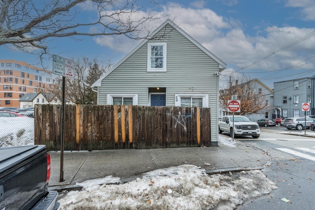 view of snow covered exterior featuring a fenced front yard