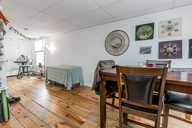 dining space featuring a paneled ceiling, visible vents, and hardwood / wood-style floors