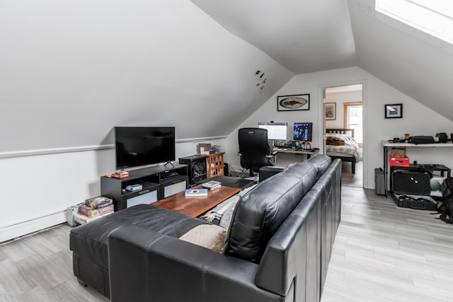 living room featuring lofted ceiling, light wood finished floors, and baseboard heating