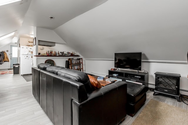 living area featuring light wood-style floors, lofted ceiling, and baseboard heating