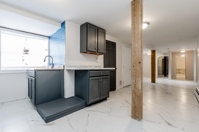 kitchen with marble finish floor and light countertops