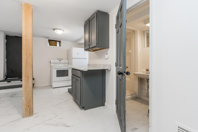 kitchen featuring marble finish floor, gray cabinets, visible vents, light countertops, and white appliances