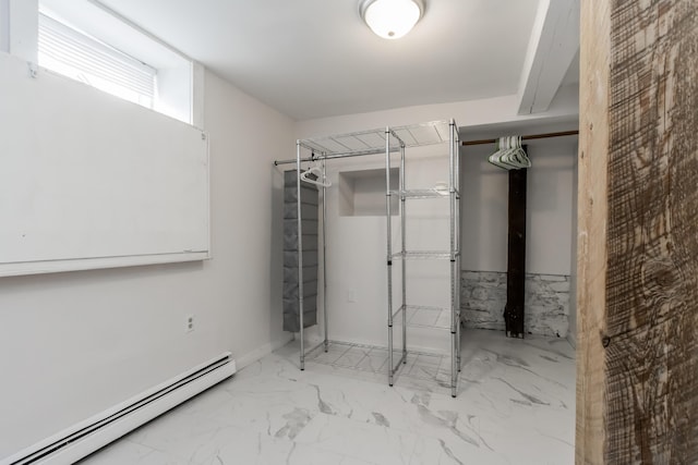 interior space with a baseboard heating unit and marble finish floor