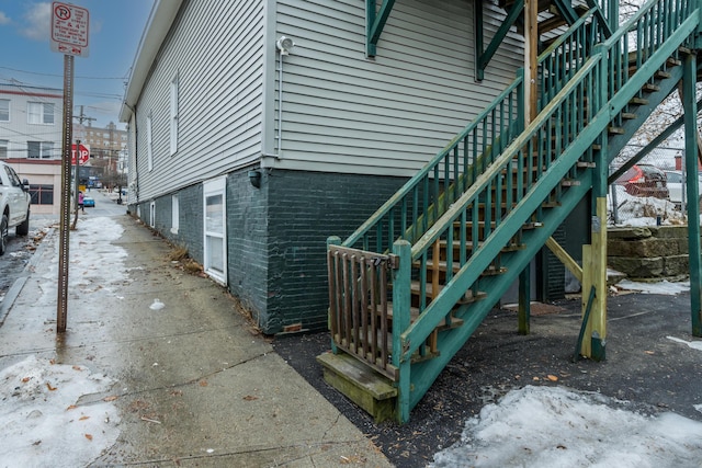 view of side of property featuring stairs and an attached garage