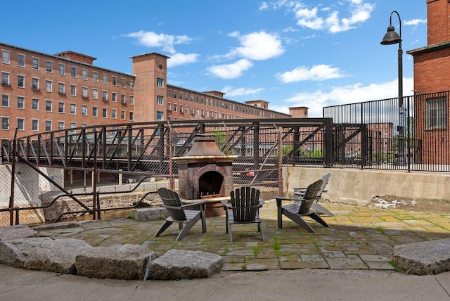 exterior space featuring fence and exterior fireplace