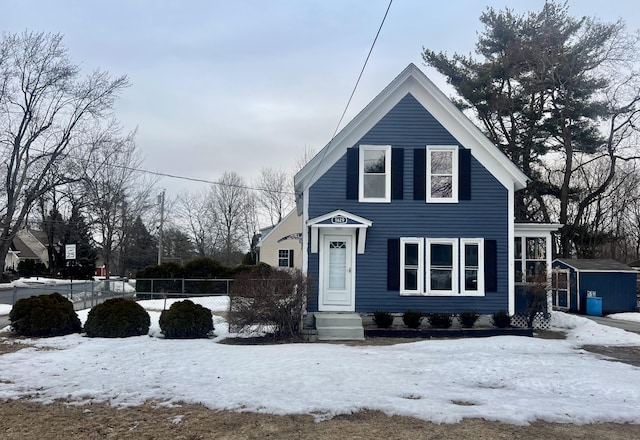 view of front of home featuring a storage shed, an outdoor structure, and fence