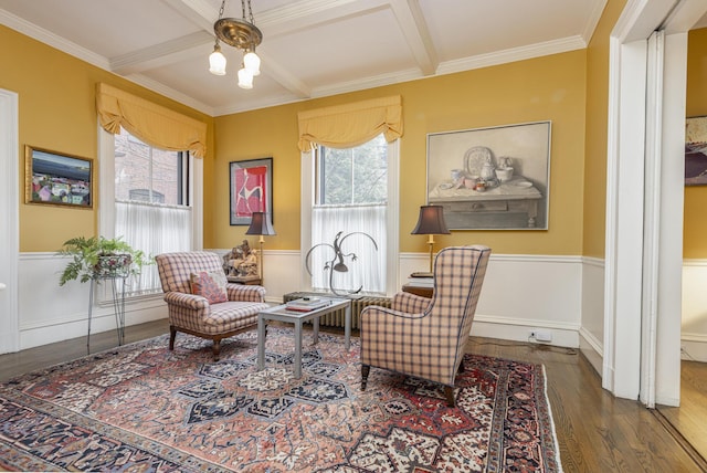 living area with a wainscoted wall, wood finished floors, coffered ceiling, and beam ceiling
