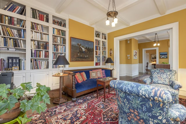 living room featuring built in features, a wainscoted wall, coffered ceiling, and beam ceiling