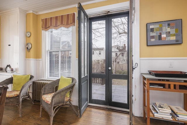 doorway to outside featuring radiator, a wealth of natural light, ornamental molding, and french doors