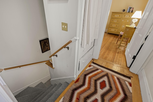 stairs featuring hardwood / wood-style flooring