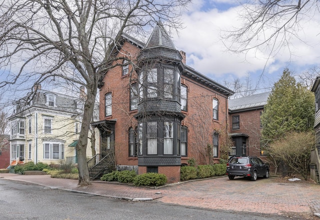 view of property featuring decorative driveway