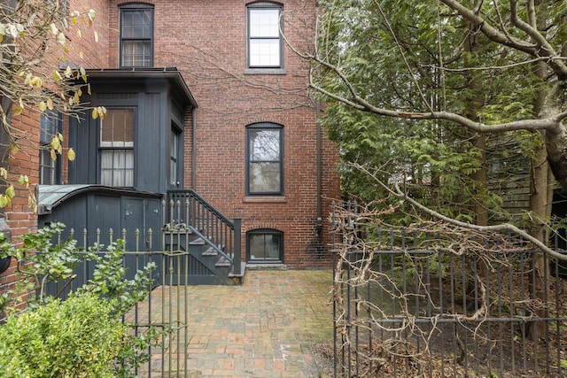 doorway to property with brick siding