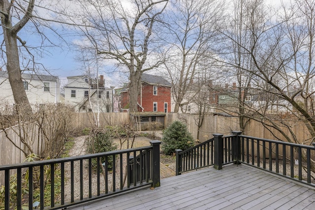 wooden terrace with a residential view and fence