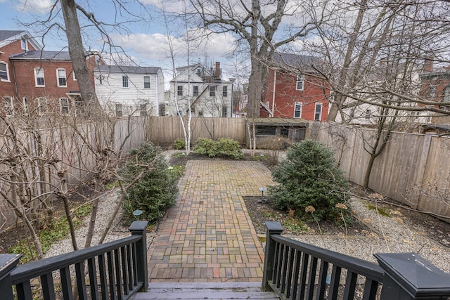 view of yard featuring a fenced backyard and a residential view