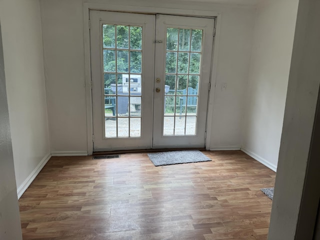 32 Maple St, Fairfield, ME 04937 - doorway featuring french doors, healthy amount of natural light, and wood finished floors