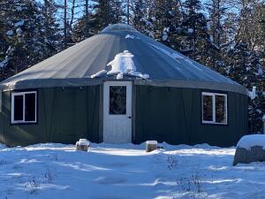 snow covered structure featuring an outdoor structure