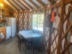 dining room featuring vaulted ceiling and concrete floors