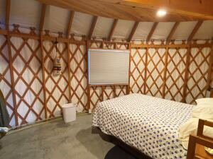 unfurnished bedroom featuring lofted ceiling and unfinished concrete floors