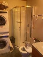 laundry area with laundry area and stacked washer / drying machine