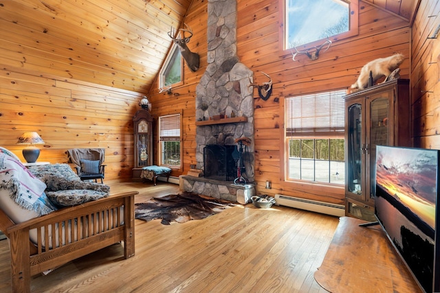 living room with hardwood / wood-style floors, high vaulted ceiling, a fireplace, wood walls, and a baseboard heating unit