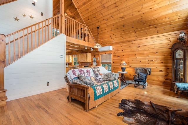 bedroom featuring a wall mounted air conditioner, high vaulted ceiling, wood finished floors, and wooden ceiling