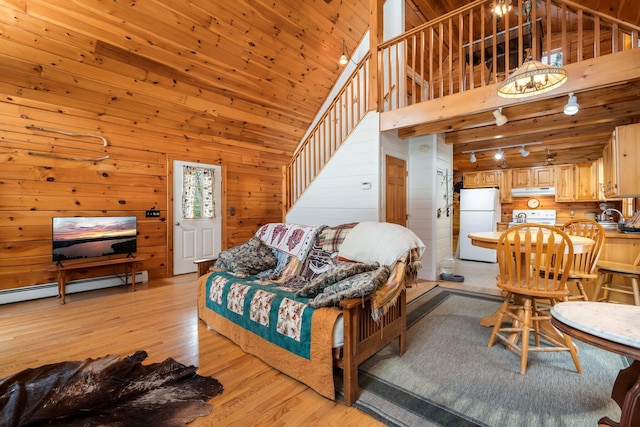 living area with wooden walls, a baseboard radiator, a high ceiling, wood ceiling, and light wood-style floors