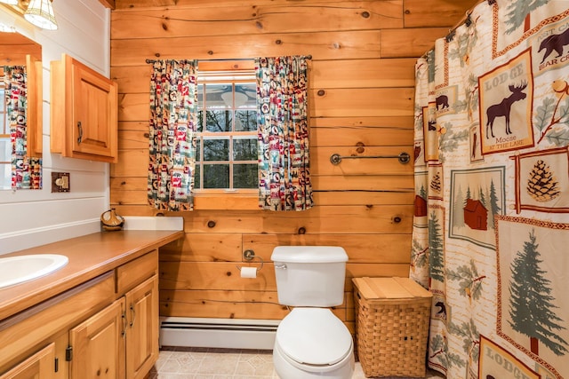 full bath featuring tile patterned flooring, wood walls, toilet, baseboard heating, and vanity