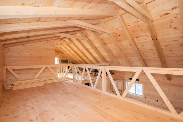 unfinished attic with an upstairs landing