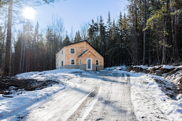 exterior space featuring a garage and a forest view