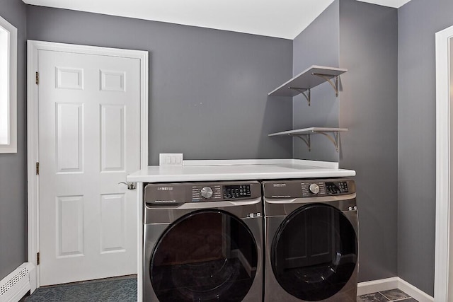 laundry area featuring laundry area, washer and clothes dryer, a baseboard radiator, and baseboards