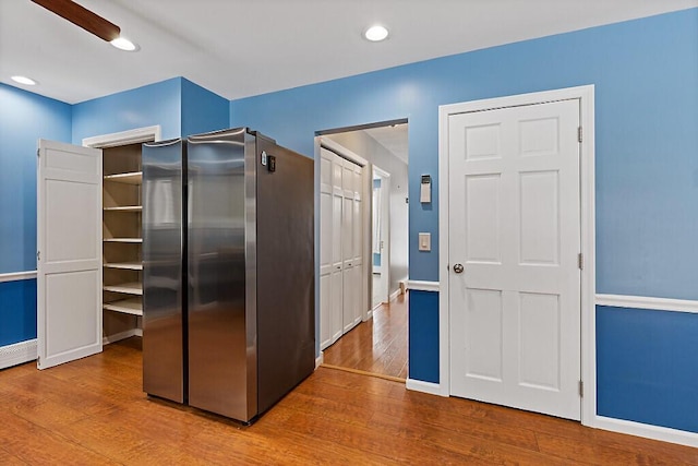 kitchen with recessed lighting, baseboards, wood finished floors, and freestanding refrigerator