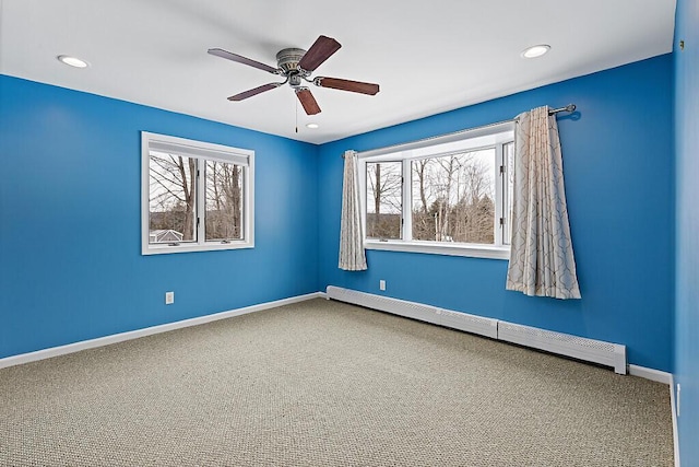 spare room with baseboards, a baseboard radiator, ceiling fan, carpet floors, and recessed lighting