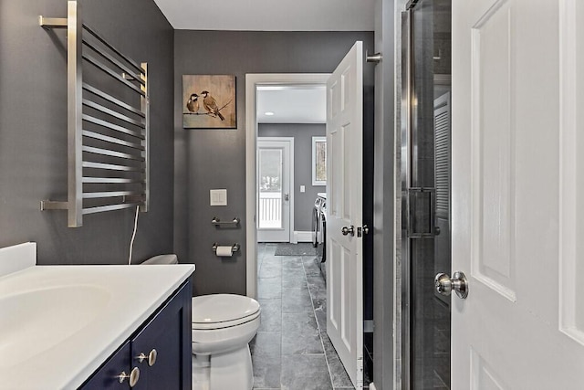 full bath featuring toilet, a tile shower, and vanity