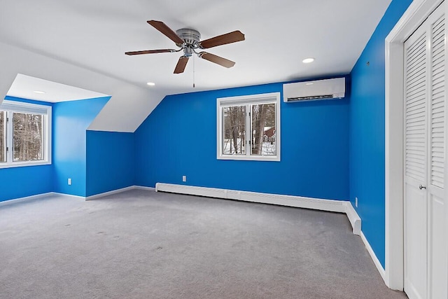 additional living space featuring carpet floors, a wall mounted AC, baseboard heating, and baseboards