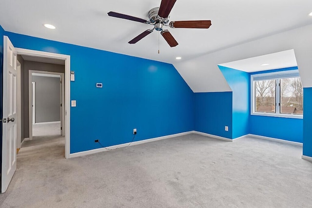 additional living space featuring vaulted ceiling, carpet floors, ceiling fan, and baseboards