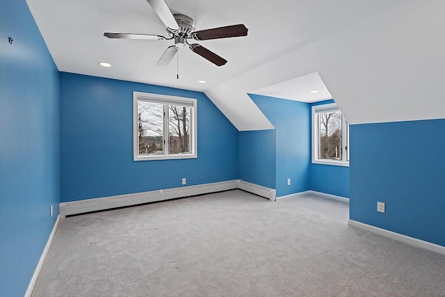 additional living space with a healthy amount of sunlight, a baseboard radiator, carpet floors, and baseboards