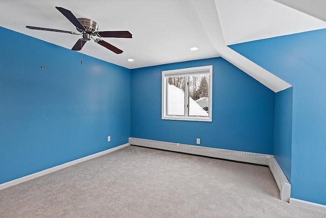 interior space featuring vaulted ceiling, a baseboard radiator, a ceiling fan, and baseboards