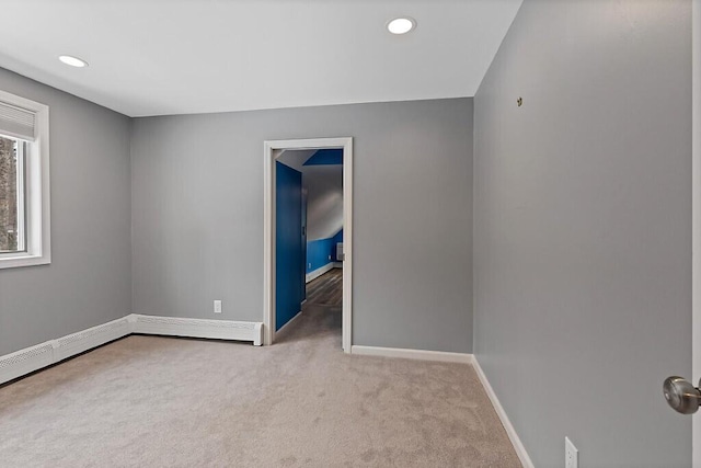 spare room featuring carpet floors, recessed lighting, and baseboards