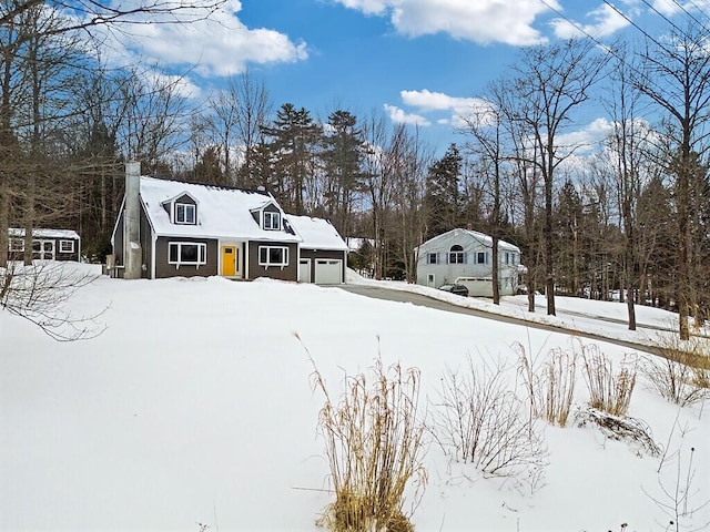 view of front of property with a garage and a chimney