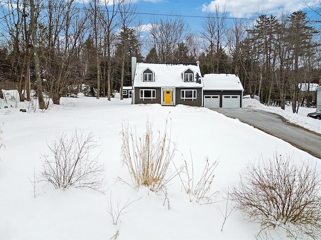 view of front of house with a chimney and aphalt driveway