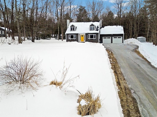 view of front of property with a garage, driveway, and a chimney