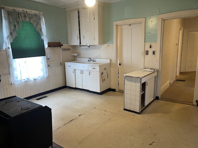 48 Gay St, Rockland, ME 04841 - kitchen featuring light floors, white cabinetry, light countertops, and baseboards