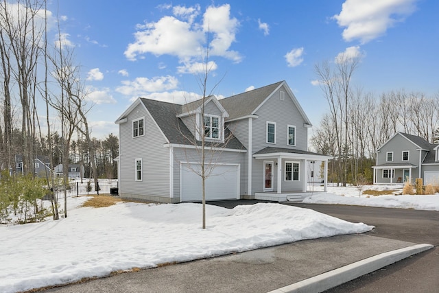 view of front of property featuring a shingled roof and a garage