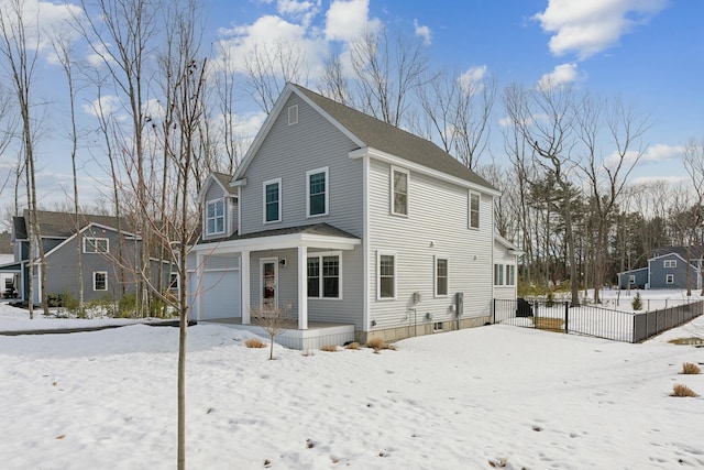 exterior space with a porch, an attached garage, and fence