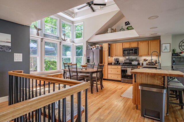 543 Middle Rd, Dresden, ME 04342 - kitchen featuring stainless steel appliances, a sink, light wood finished floors, a raised ceiling, and a high ceiling